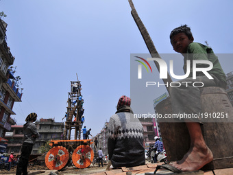 Nepalese people watching as Devotees arranging piles of wood for making the chariot of Idol Rato Machindranath 'Rain of God' at Pulchowk, La...