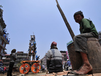 Nepalese people watching as Devotees arranging piles of wood for making the chariot of Idol Rato Machindranath 'Rain of God' at Pulchowk, La...