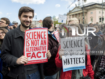 People attending the 'March for Science' hold banners reading 'science is not an alternative fact' and 'science matters' in Berlin, Germany...
