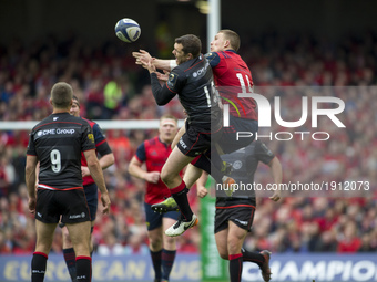 Andrew Conway of Munster jumps for the ball with Alex Goode of Saracens during the European Rugby Champions Cup Semi-Final match between Mun...