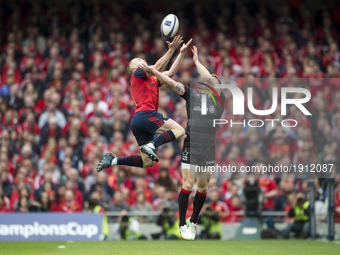 Keith Earls of Munster jumps for the ball with Chris Ashton of Saracens during the European Rugby Champions Cup Semi-Final match between Mun...