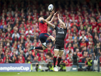 Keith Earls of Munster jumps for the ball with Chris Ashton of Saracens during the European Rugby Champions Cup Semi-Final match between Mun...
