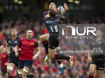 Simon Zebo of Munster jumps for the ball with Alex Goode of Saracens during the European Rugby Champions Cup Semi-Final match between Munste...