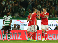 Benfica's Swedish defender Victor Lindelof (14) celebrates with teammates after scoring during the Portuguese League football match Sporting...