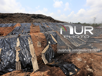 A general view of the site of the collapsed garbage mountain that is being covered with black colored polythene by Sri Lankan Army personnel...