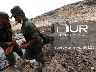  Sri Lanka Army  personnel cover   the site of the collapsed garbage mountain with black colored polythene at Meetotamulla, in Colombo, Sri...