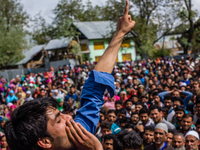 Kashmiri Muslims shout anti Indian and pro Kashmir freedom slogans as they attend the funeral procession of   Younis Maqbool Ganie, a pro Ka...