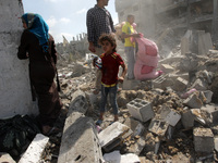 Palestinians inspect the rubble of destroyed houses in the Shejaia neighbourhood, which witnesses said was heavily hit by Israeli shelling a...