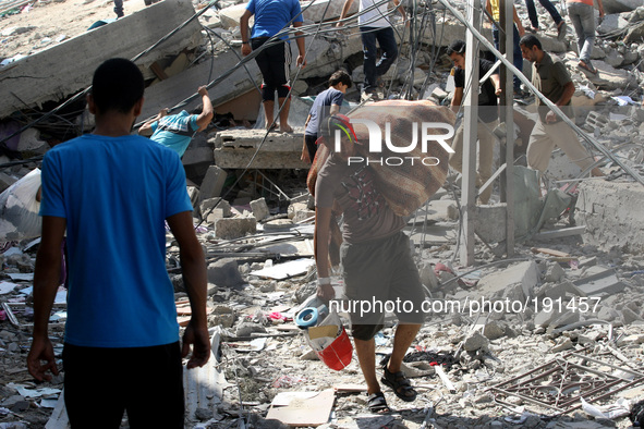 Palestinians inspect the rubble of destroyed houses in the Shejaia neighbourhood, which witnesses said was heavily hit by Israeli shelling a...