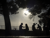 Some young people enjoy the sunset view at Grazia viewpoint in Lisbon (Portugal)
 (