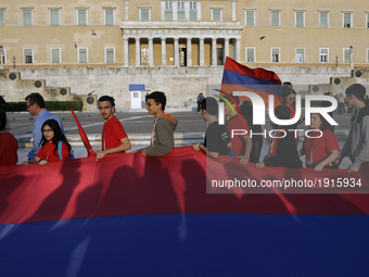 Armenians who live in Greece march in front the Greek Parliament holding the Armenian flag, in Athens, on Monday April 24, 2017. Hundreds of...