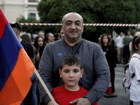 A father with his son demonstrate near the Turkish embassy in central Athens, on Monday April 24, 2017. Hundreds of Armenians who live in Gr...