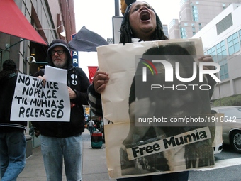 A Mumia supporter emotionally chants no justice no peace until Mumia is released, while holding a poster of Mumia Abu-Jamal outside the Crim...