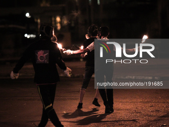 Bahrain , Sitra - protesters holding molotov cocktail during the clashes , heavy clashes between protesters and riot police after suppressin...