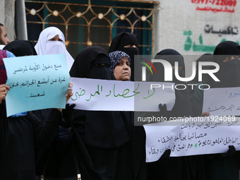Palestinian women hold placards during a protest demanding end an Israeli blockade of the Gaza Strip, at Al-Shifa hospital in Gaza City on A...