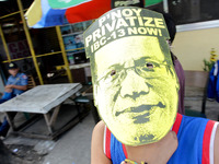Quezon City, Philippines - A boy shows a mask of President Benigno Aquino III during the President's State of the Nation Address (SONA) held...
