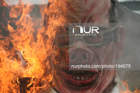 The effigy of President Benigno Aquino III as fire consumes it after being lit by protesters along Commonwealth Avenue in Quezon City. Thous...