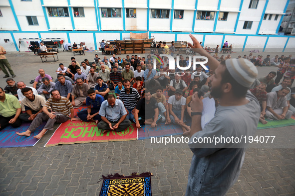 Displaced Palestinians attend the Eid al-Fitr prayer at a United Nations school, in Jabalia in the northern Gaza Strip, on July 28, 2014. 