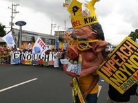 A protester wearing an effigy of president Aquino leads the crowd as they march towards Batasan Pambansa in Quezon City. Thousands of protes...