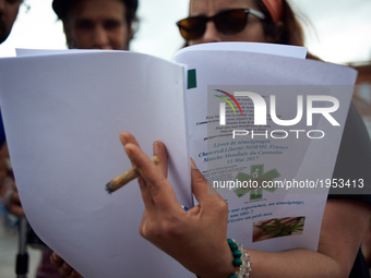 A woman informs a passe-by while smoking marijuana. For the Global Marijuana March, supporters of legalization for medical and recreationnal...