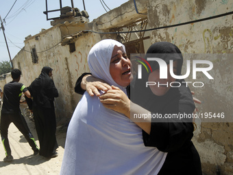 A Palestinian relatives mourn during the funeral for fifteen members of the Abu zeid, Duheir and al-Hashash families, that were killed in an...