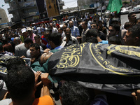 A Palestinian relatives carry the body of a killed in an Israeli air strike on their home, during his funeral in Rafah in the southern Gaza...