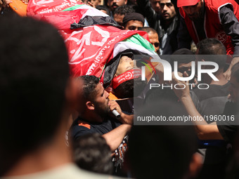 Palestinian mourners carry the body of Mohammed Majed Bakr, a 25-year-old fisherman who died from his injuries after an Israeli patrol vesse...