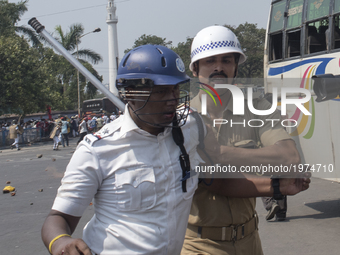 A policeman has got injured during the protest rally while the other is escorting him to a safe place. Kolkata, India, 22 May 2017 After the...