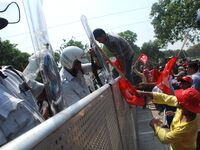 Indian Leftist activists try to break the police barricade during march towards the state  Government head quarters in Kolkata , India on Mo...