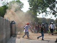 Indian Leftist activists throwing stones as they try to break the police barricade during march towards the state  Government head quarters...
