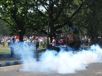 Police fire tear gas to Indian Leftist activists as they try to break the police barricade during march towards the state  Government head q...