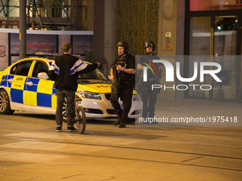 Police officers guard the cordoned off area, outside the Manchester Arena, after an explosion after the Ariana Grande concert which took pla...