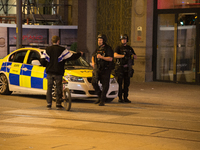 Police officers guard the cordoned off area, outside the Manchester Arena, after an explosion after the Ariana Grande concert which took pla...