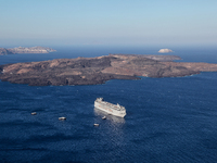 Cruise ship in the Aegean Sea by the Caldera near Santorini Island, Greece. (