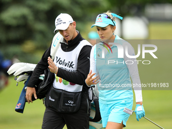 Lexi Thompson of the United States talks to caddy on the 11th hole during the first round of the LPGA Volvik Championship at Travis Pointe C...