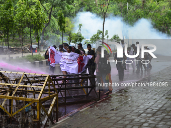Bangladeshi policeman lob several tear gas canisters and use water cannons to disperse activists protesting against the removal of a Lady Ju...