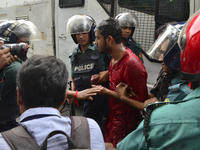 Bangladeshis policeman arrested a activists during a protest against the removal of a Lady Justice statue in Dhaka, Bangladesh, on May 26, 2...