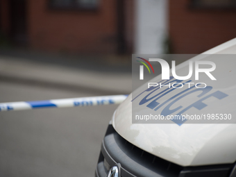 A police van guards a cordoned off street, a place where part of the investigation in to the Manchester Arena explosion is taking place, in...