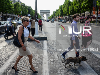 People are crossing champs Elysees Boulevard in Paris, France on May 28, 2017. Much of French people and tourists enjoyed hot and sunny weat...