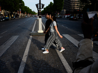People are crossing champs elysees boulevard in Paris, France on May 28, 2017. Much of French people and tourists enjoyed hot and sunny weat...
