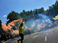 People holding smoke bombs march during a protest by a Spanish taxi drivers in Madrid on 30 th May, 2017. (