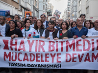 Families of killed protesters march with a banner reading : 