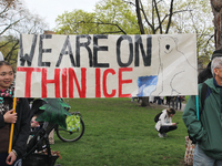 Demonstrators hold a banner saying 'we are on thin ice' as hundreds of Canadians took part in a massive march against climate change during...