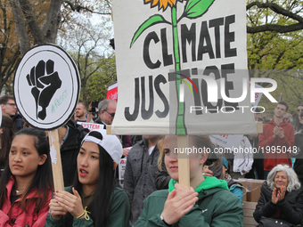 Demonstrator holds a sign saying 'climate justice' as hundreds of Canadians took part in a massive march against climate change during the N...
