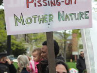 Demonstrator holds a sign saying 'stop pissing off mother nature' as hundreds of Canadians took part in a massive march against climate chan...