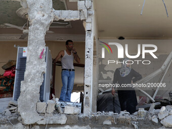 Palestinians inspect the destroyed house in Beit Hanoun , which witnesses said was heavily hit by Israeli shelling and air strikes during an...