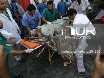 A Palestinian man body arrives at the al-Kuwaiti hospital a after an Israeli air strike in Rafah, in the southern Gaza Strip on August 2, 20...
