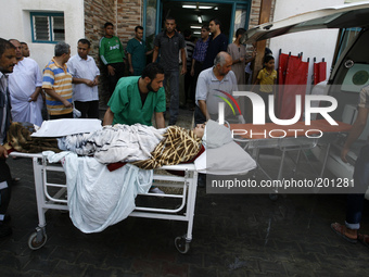 A wounded Palestinian woman arrives at the al-Kuwaiti hospital a after an Israeli air strike in Rafah, in the southern Gaza Strip on August...