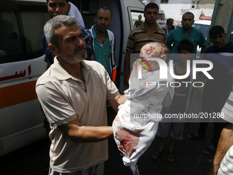 Palestinian relatives carry the body of two month old Noor al-Saidy, killed during attacks on the Gaza Strip, during her funeral in Rafah, i...