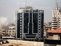 Smoke rises from Al Zafer tower apartment damaged by an Israeli strike in Gaza City . on August 3, 2014 as the Israeli-Hamas conflict enters...